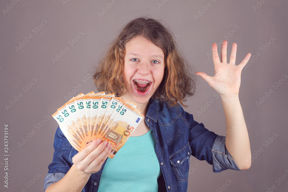 Teen girl holds in her hand euro. Teen girl holds in her hand euro.