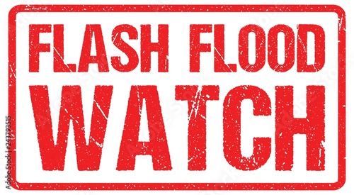 A road warning sign against a stormy sky with words Flash Flood Area, Flood Warning