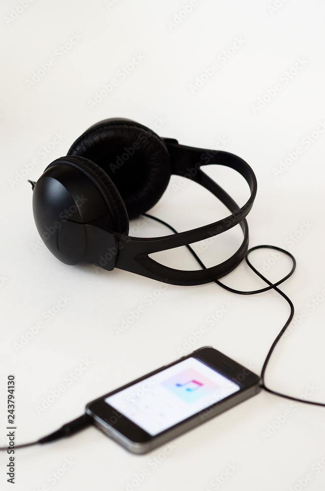 black headset and phone are on a white background black headset and phone are on a white background