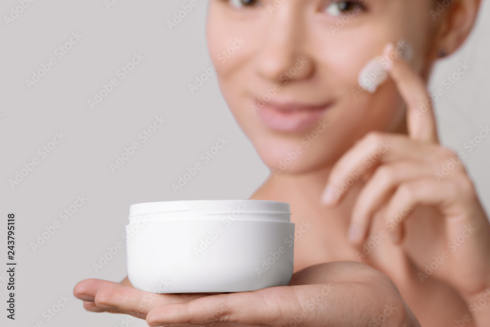 Woman Holding Cosmetic Cream. Beauty Face. Beautiful Woman With Natural Makeup. Girl With Clean Fresh Skin. Closeup. High Resolution Woman Holding Cosmetic Cream. Beauty Face. Beautiful Woman With Natural Makeup. Girl With Clean Fresh Skin. Closeup. High Resolution