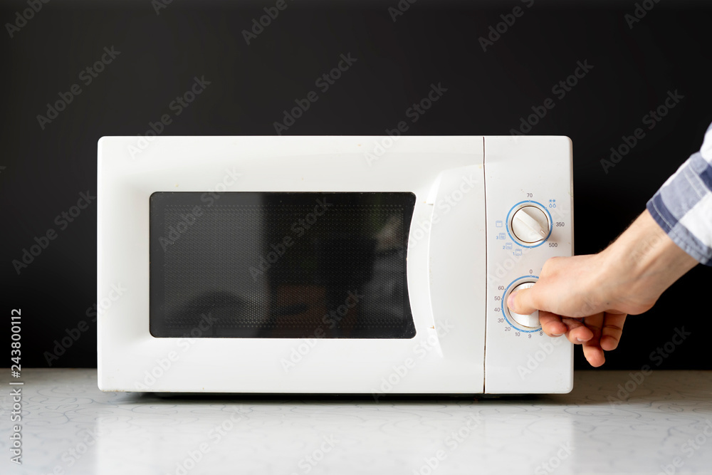closeup photo of man use microvave oven to heat the food f closeup photo of man use microvave oven to heat the food f