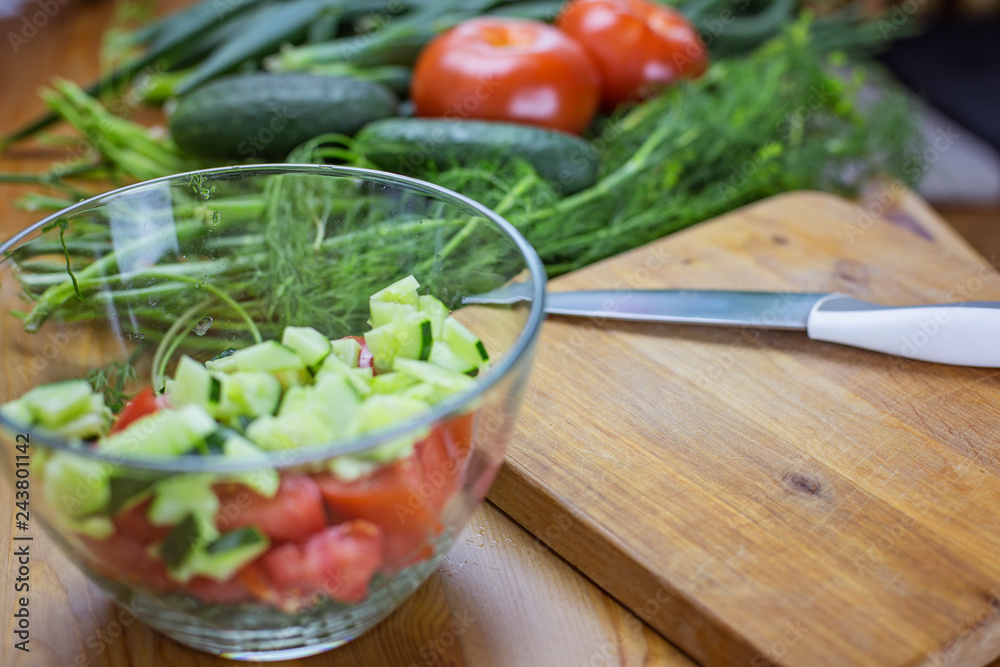 Sliced vegetables for salad lie in transparent dishes