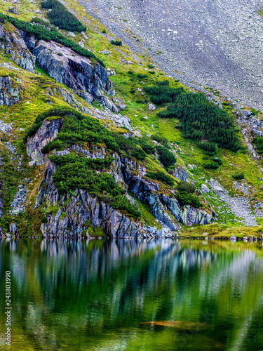 Fototapeta Naklejka Na Ścianę i Meble -  Mountain slope with small lake at botom