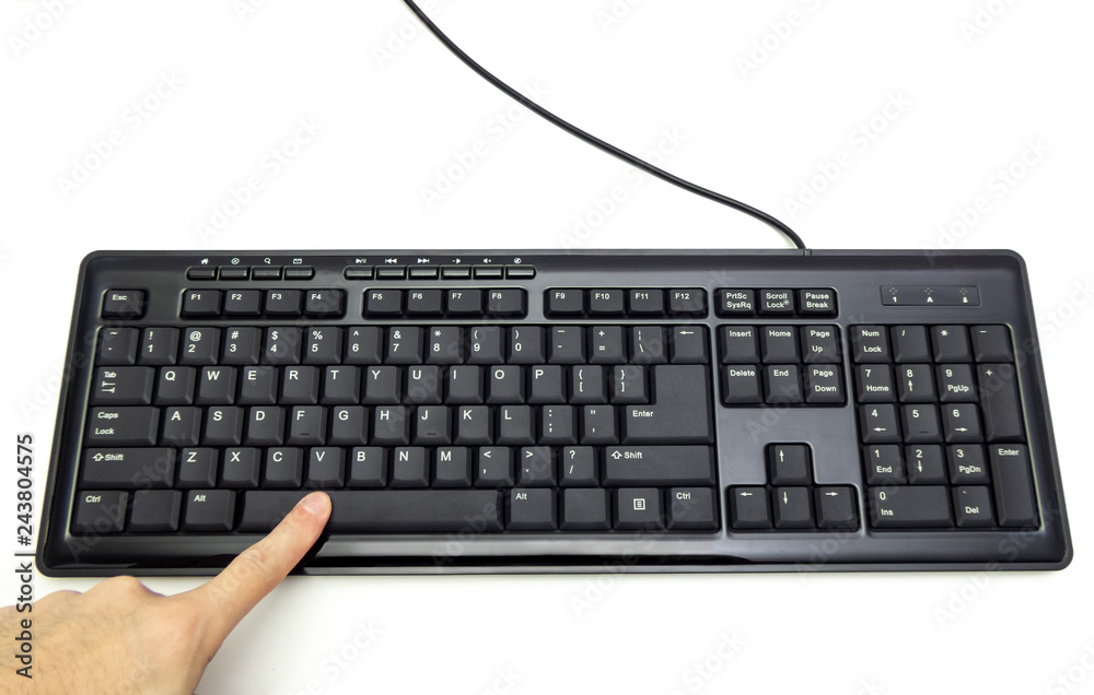 Finger pressing Spacebar button on the black keyboard