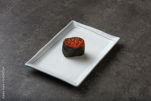 Salmon eggs or Ikura in Japanese style sushi fresh from raw salmond fish in studio lighting. photo