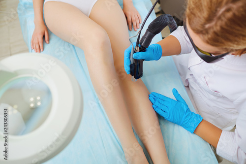 Laser therapy. Hair removal on a womanâs legs by a laser.