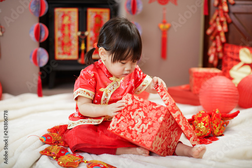 Chinese baby girl  traditional dressing up celebrate Chinese new year open gift box
