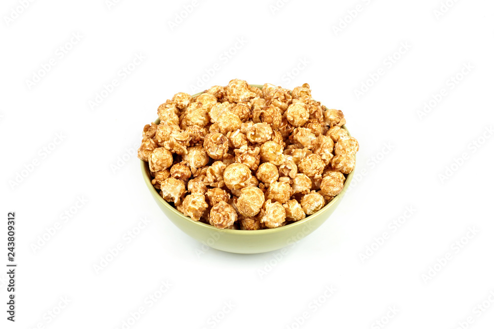 caramel popcorn in a bowl on a white background