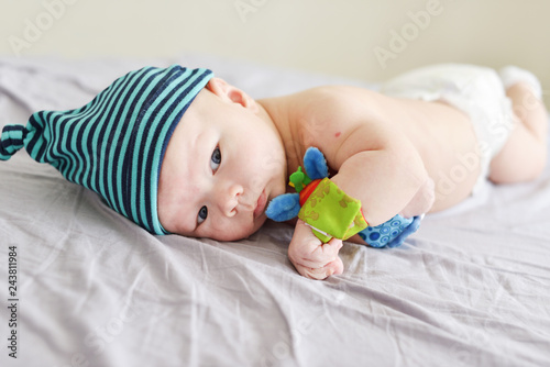 baby with bracelet toys on hands photo