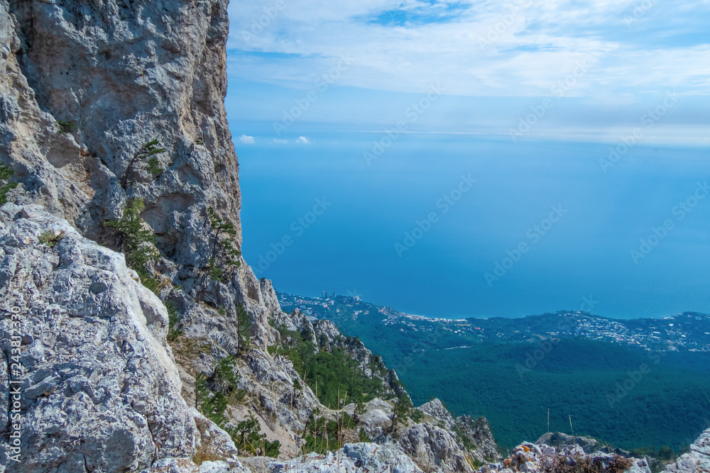 A beautiful landscape on the wall of Mount Ai Petri, the town of Gaspra and the Black Sea in Crimea, background with vignette.