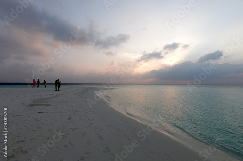 sunset on a tropical beach in maayafushi island, maldives