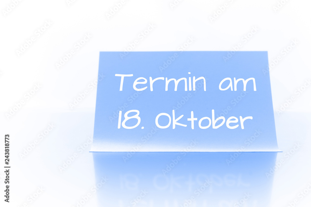 Termin am 18. Oktober - blauer Zettel mit Notiz Termin am 18. Oktober - blauer Zettel mit Notiz