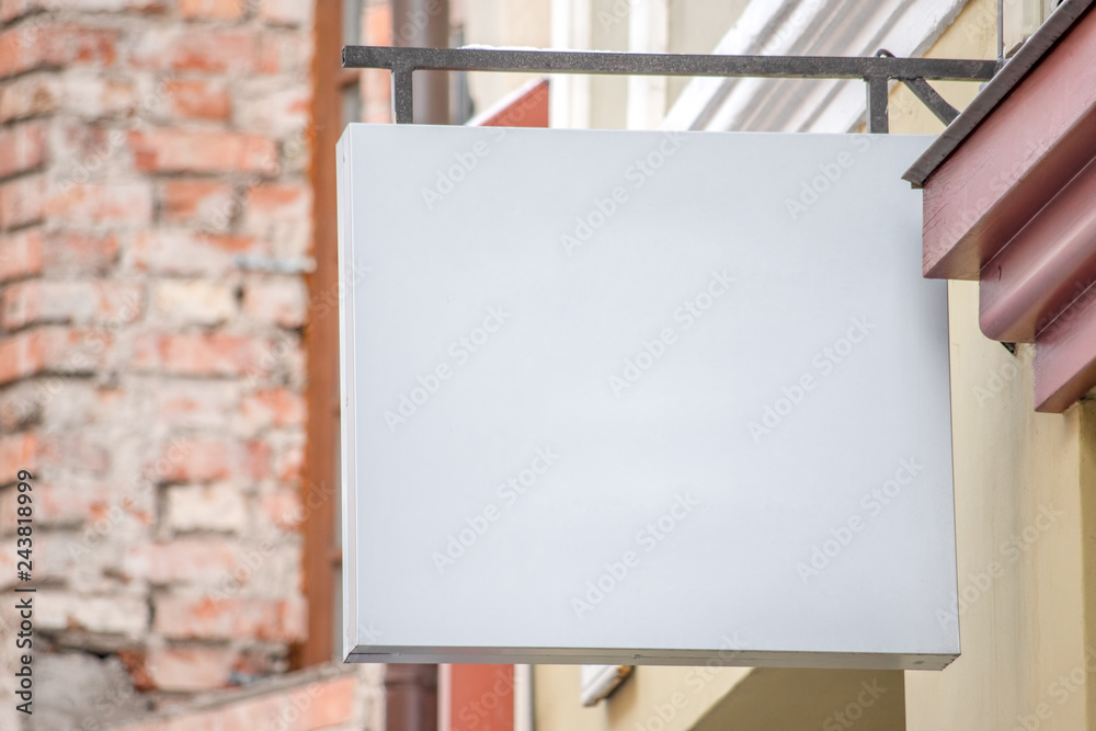 Mock up. Blank white signboard of store or restaurant on the wall Mock up. Blank white signboard of store or restaurant on the wall