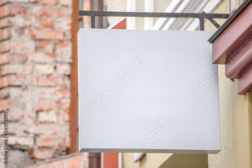 Mock up. Blank white signboard of store or restaurant on the wall
