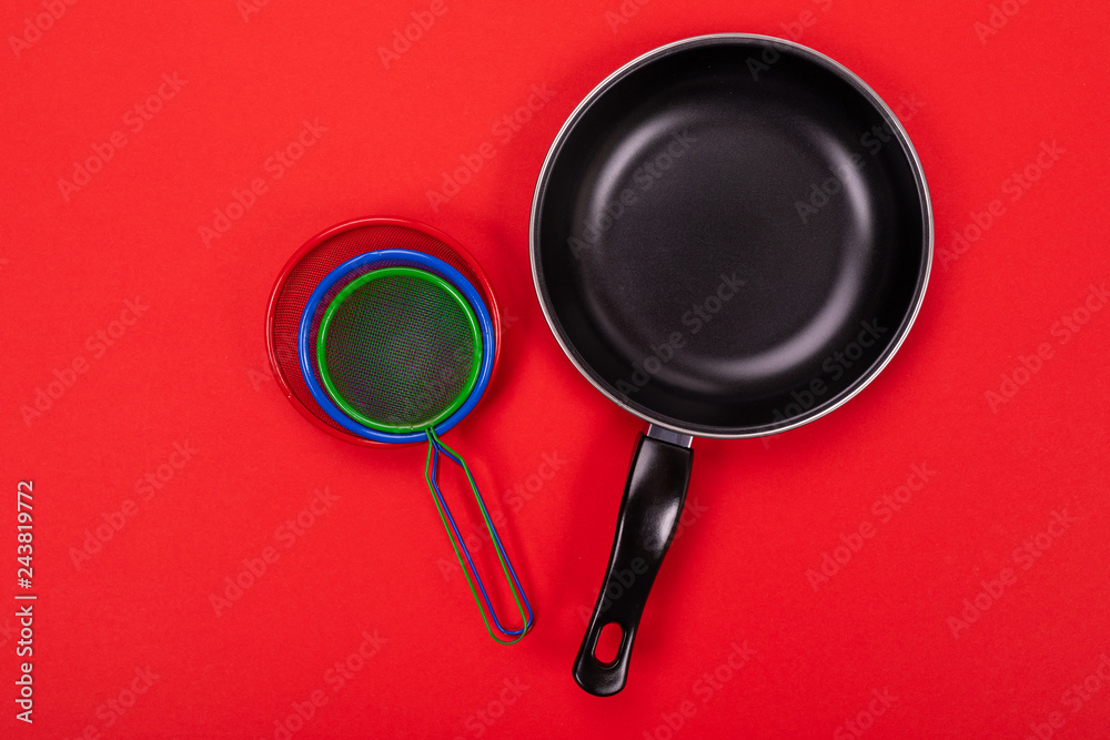 Cooking utensils in kitchen isolated on red background with copyspace