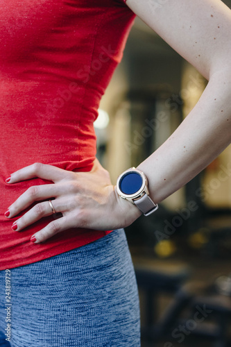 healthy lifestyle concept. fitness woman after workout session checks results on smartwatch in fitness app. detail of female athlete wearing sport tracker wristband arm