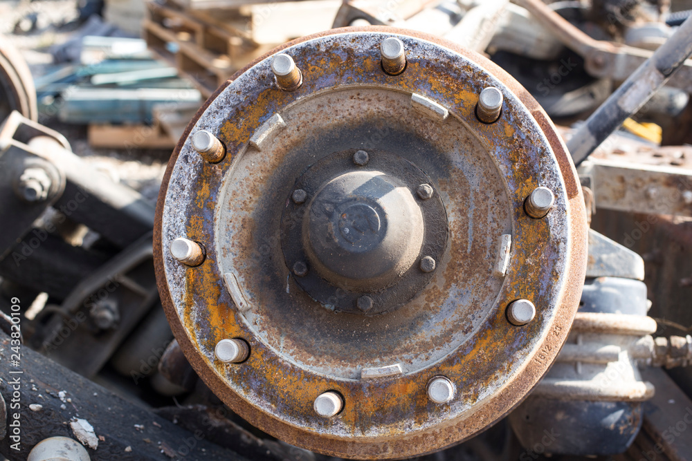 rusty metal wheel rims in the car dump, vehicle waste
