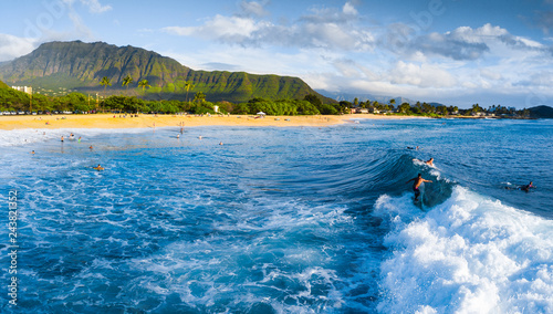 Panorama of the surf spot Makaha with the surfer riding the wave. Oahu, Hawaii photo