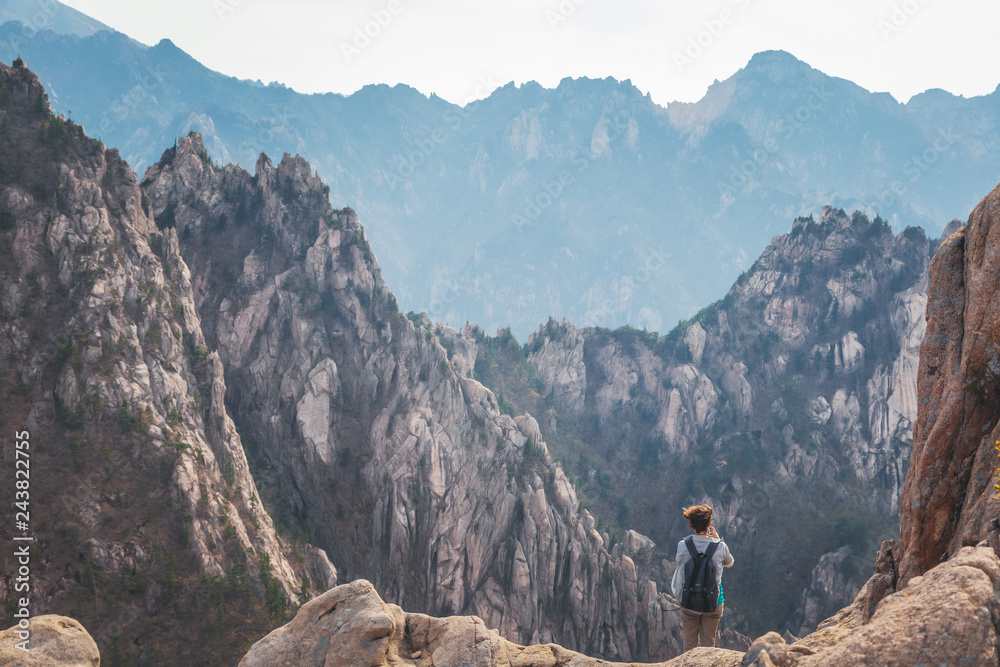 A girl traveling in a gorge in the mountains of Seoraksan National Park in South Korea, a popular destination for travel in Asia