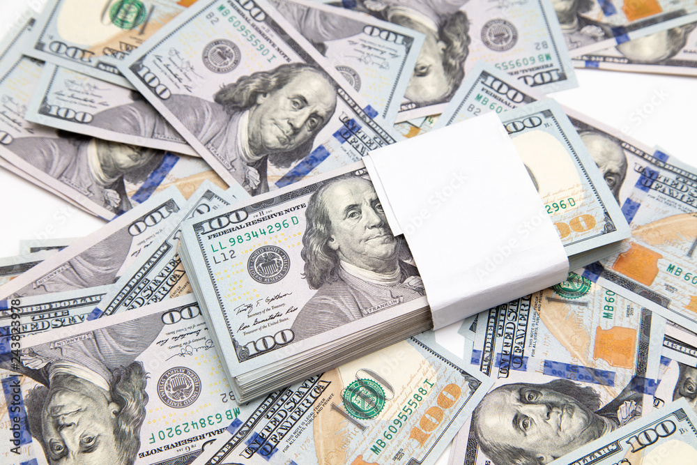 One hundred dollar bills on the table as background One hundred dollar bills on the table as background