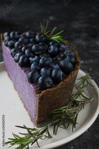 Blueberry vegan cheesecake. Dark photo on black background photo