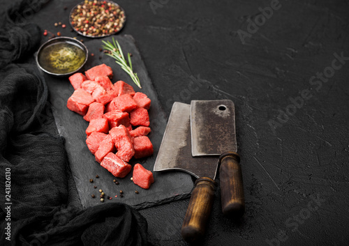 Εκτύπωση καμβά Raw lean diced casserole beef pork steak on chopping board with vintage meat hatchets on stone background