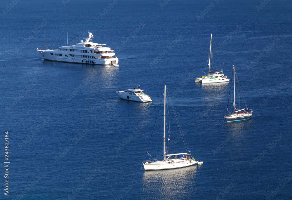 Yachts and boats in crystal clear azure water at Paleokastritsa. Corfu island, Greece. Holidays in Greece.