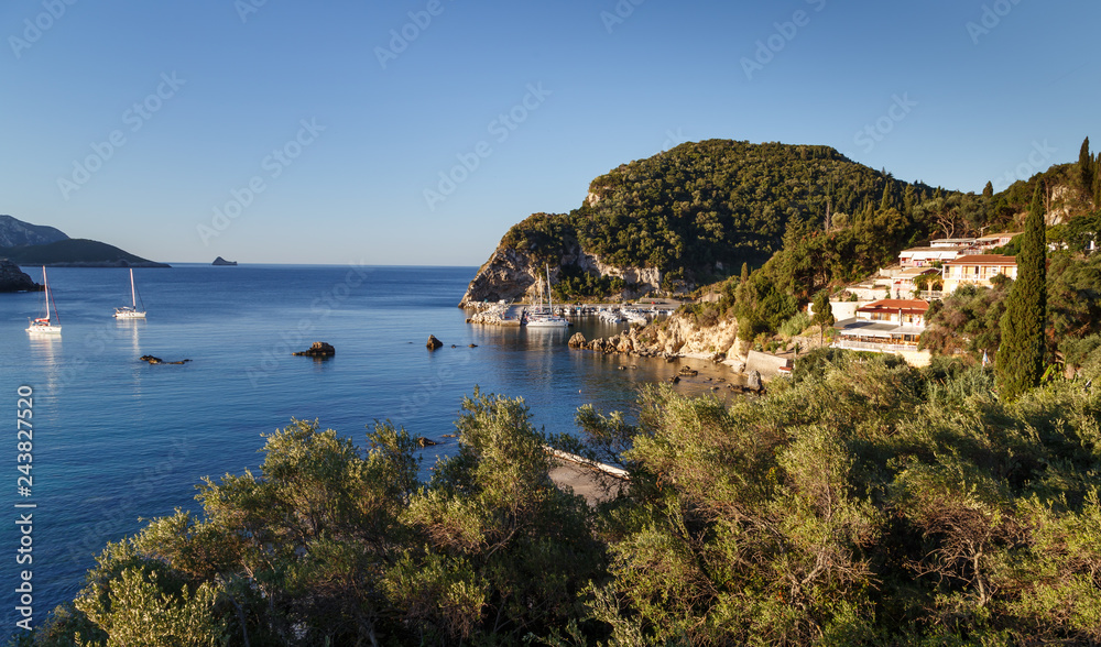 View to the sea bay with yachts and boats in crystal clear azure water at Paleokastritsa. Panoramic landscape. Corfu island, Greece. Holidays in Greece.