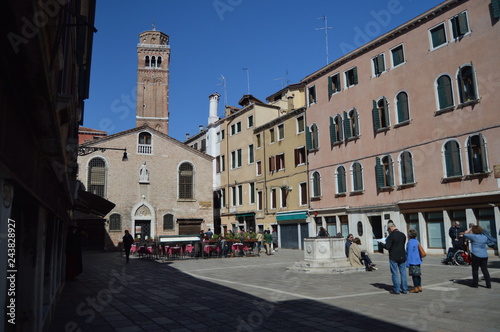 Strolling through the Sestiere of San Polo, from Scuola dei Calegheri to San Rocco. With the Frari Bell Tower in the background In Venice. Travel, Holidays, Architecture. March 27, 2015. Italy.