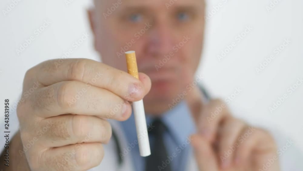 Anti Tobacco Campaign with Doctor Showing a Cigarette and Making No Finger Sign Anti Tobacco Campaign with Doctor Showing a Cigarette and Making No Finger Sign