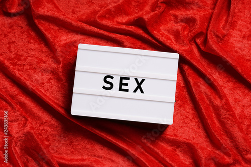 sex or sexuality abstract concept without people, word on lightbox or light box sign on red velvet background