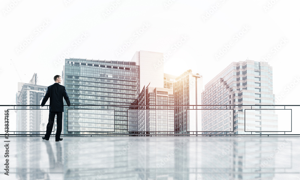 Sunrise above skyscrapers and businessman facing new day Sunrise above skyscrapers and businessman facing new day