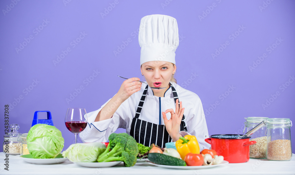 Cooking healthy food. Fresh vegetables ingredients for cooking meal. Professional cooking tips. Woman chef try taste food. Gourmet main dish recipes. Delicious recipe concept. Girl in hat and apron Cooking healthy food. Fresh vegetables ingredients for cooking meal. Professional cooking tips. Woman chef try taste food. Gourmet main dish recipes. Delicious recipe concept. Girl in hat and apron