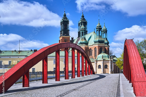 Steel bridge over the river Warta and the towers of the cathedral in Poznan..