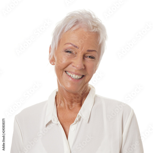 happy smiling older lady in her sixties with trendy white short haircut