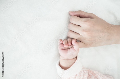 New Born Baby hand hold finger of mom: concept of love, take care, parent relationship