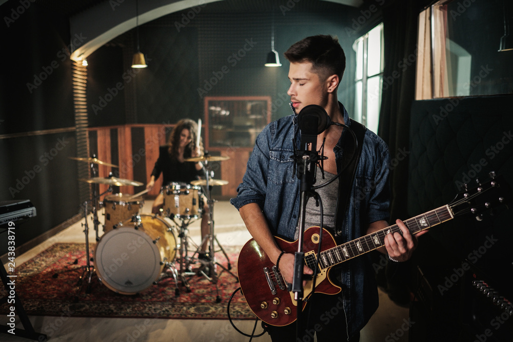 Fototapeta premium Music band having rehearsal in a studio