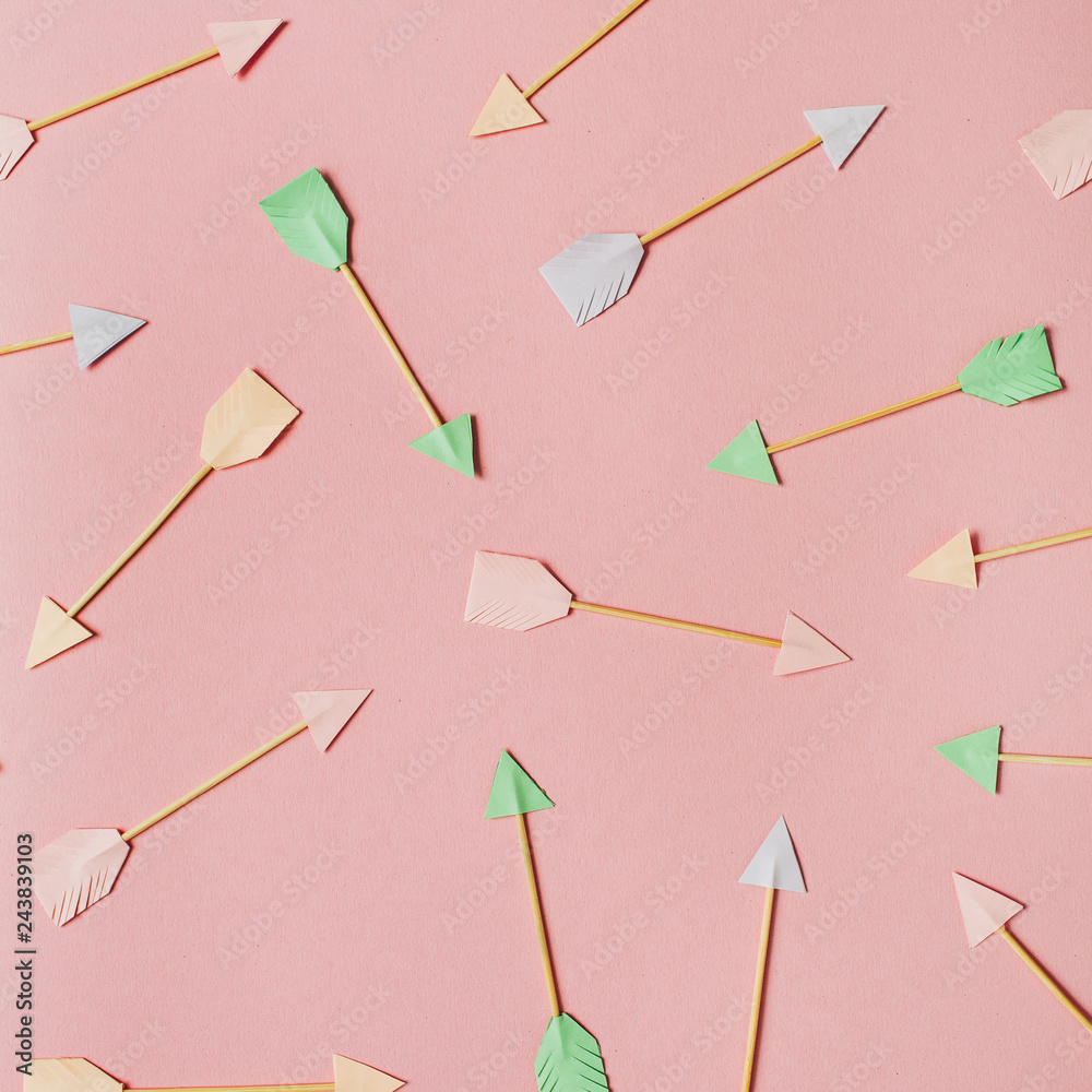 Paper Cupid arrows on pink background. Flat lay, top view Valentines Day background love concept. Paper Cupid arrows on pink background. Flat lay, top view Valentines Day background love concept.