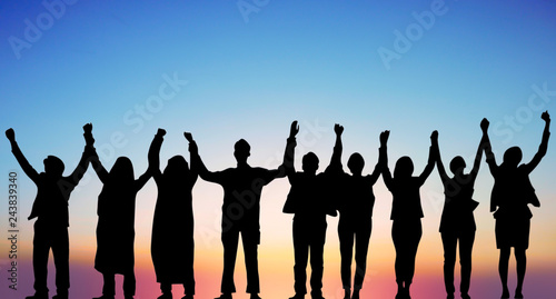 Success of teamwork collaboration and freedom on silhouette sunset background. business concept.