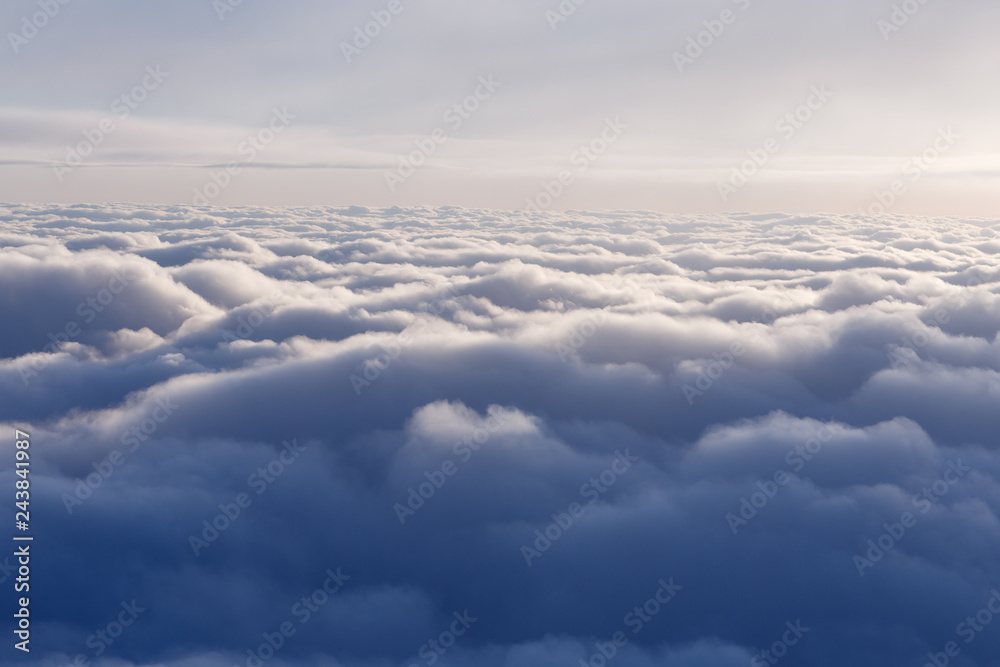 Naklejka premium View from the window of an airplane flying above the clouds