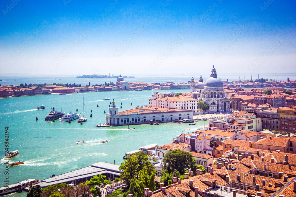 Panoramic view of Venice - Basilica Santa Maria della Salute, Grand Canal with gondolas and red tiled roofs of houses, Venice, Italy