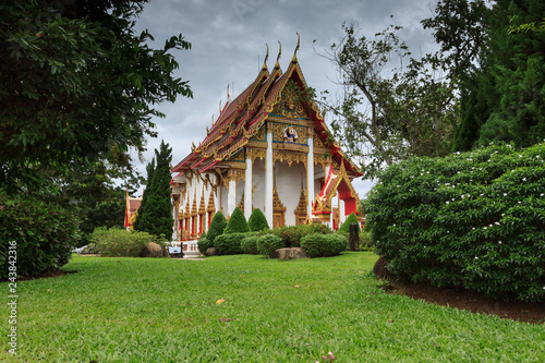 Phuket, Thailand. Beautiful green garden and building on the territory of the Buddhist temple Wat Chalong (Wat Chaiyathararam)