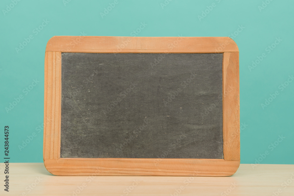 Chalkboard with wooden frame on a blue background Chalkboard with wooden frame on a blue background