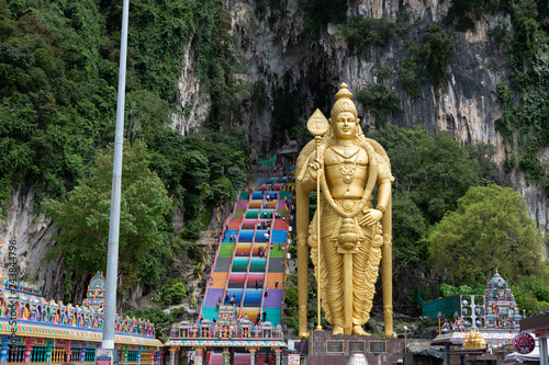 The Batu Caves Lord Murugan Statue and entrance near Kuala Lumpur Malaysia. A limestone outcrop located just north of Kuala Lumpur, Batu Caves has three main caves featuring temples and Hindu shrines.