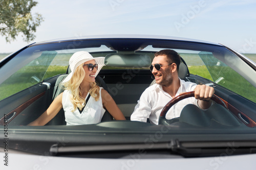 leisure, road trip, dating, couple and people concept - happy man and woman driving in cabriolet car outdoors © Syda Productions