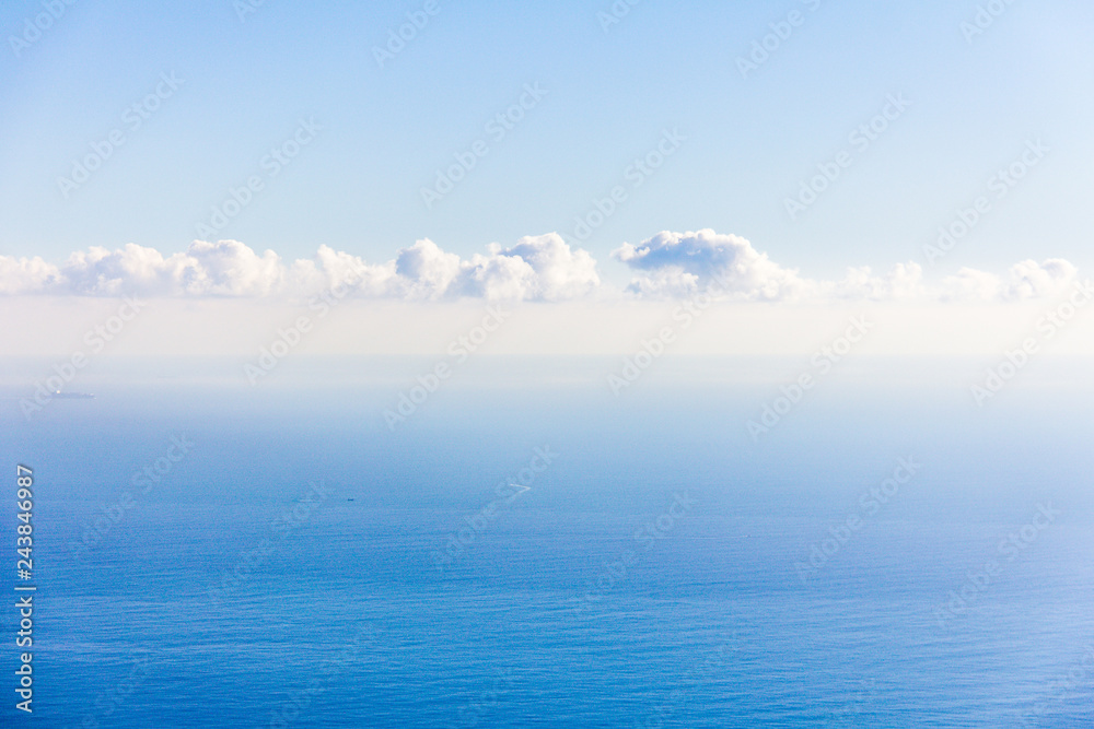 Clouds over the Mediterranean sea. Some ships in the sea.