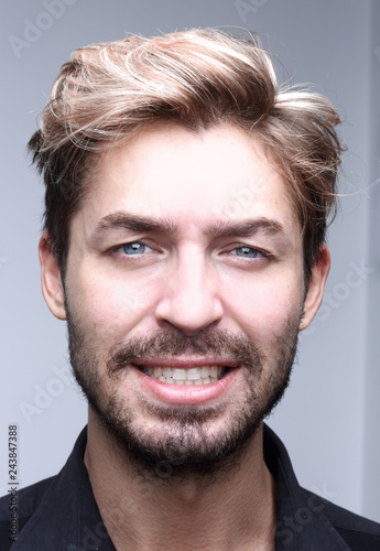 Close up portrait of smiling man on a gray background