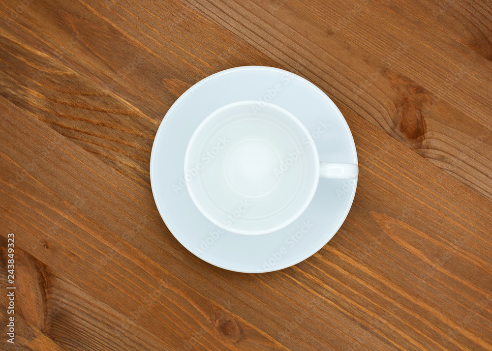 Empty coffee couple white cup and saucer. Top view, isolated on wooden background Empty coffee couple white cup and saucer. Top view, isolated on wooden background