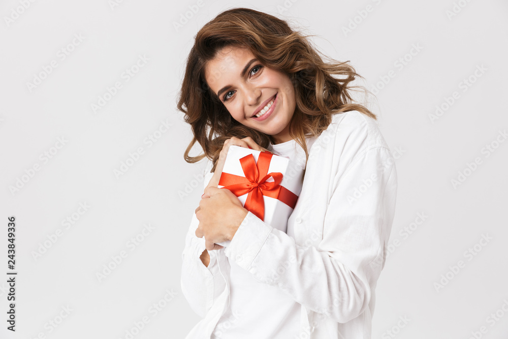 Portrait of happy woman in casual clothes holding present box, isolated over white background Portrait of happy woman in casual clothes holding present box, isolated over white background