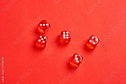 five red dice view from above on red background